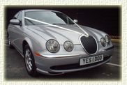 Silver S-type Jaguar with the number plate which says "yes I do "